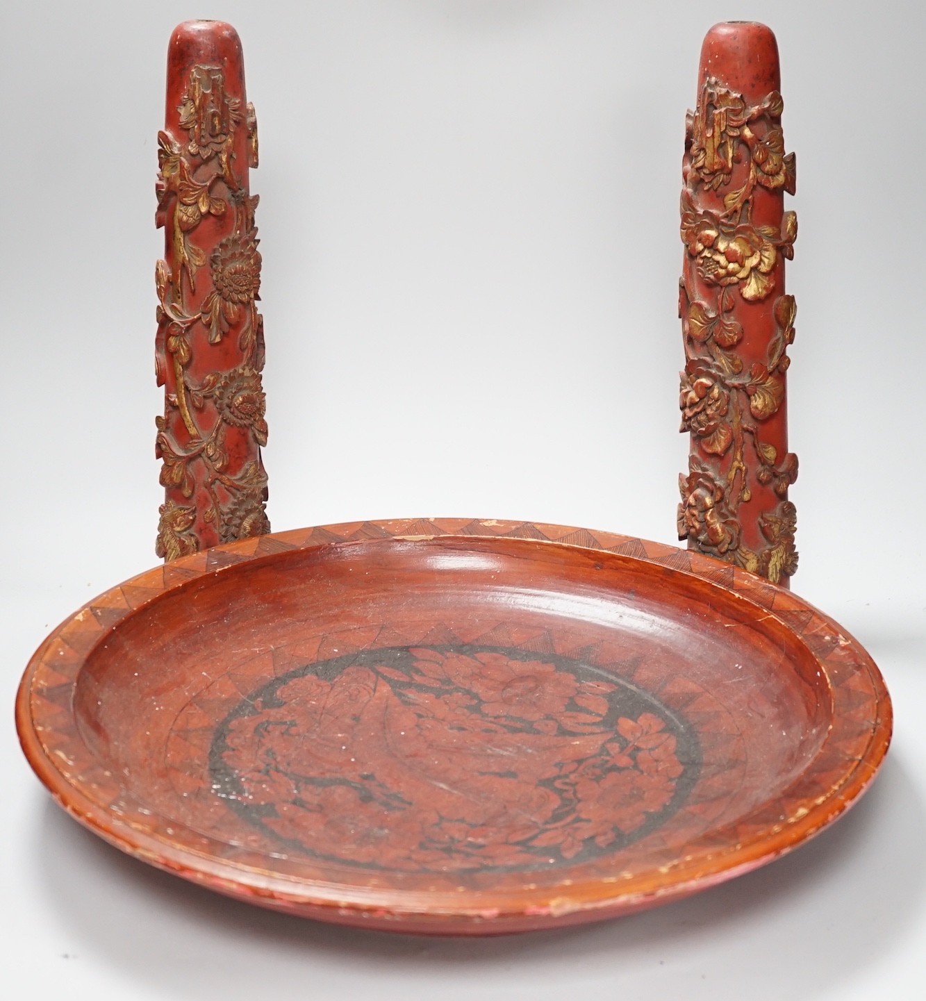A pair of early 20th century Chinese carved red lacquer and gilt temple incense burners and a similar Asian lacquer dish, dish 44.5cms diameter